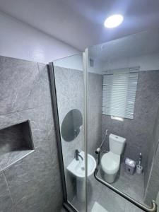 a bathroom with a toilet and a sink at The Adun Grove in Lekki +12 photos