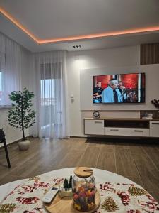 a living room with a flat screen tv on a wall at Apartman IVA in Modriča +8 photos