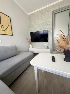 a living room with a couch and a table at Dionis House in Shkodër