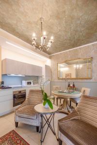 a living room with two couches and a table at Corte Realdi Suites Arena Verona in Verona