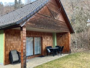a house with a patio with a table and chairs at Ferienhaus Stolz in Sankt Peter am Kammersberg