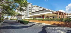 a building with a walkway in front of a building at R&N Trees Residence in Manila