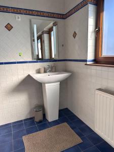 a bathroom with a white sink and a mirror at Apartment Kala in Varaždin +3 photos