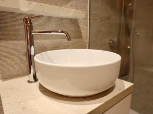 a white sink with a faucet in a bathroom at Chalet Olive in Durbuy