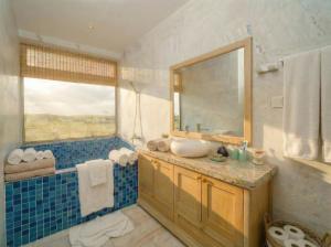 a bathroom with a sink and a mirror at Entire Hoi An Villas By Ovui in Hoi An +87 photos