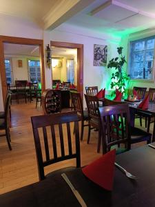 a restaurant with tables and chairs and green lights at Pension Webstuhl in Deizisau