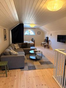 a living room with a couch and a table at Kyrkåsen in Borgvik