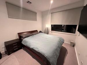 a bedroom with a large bed and a window at The elite Home in Rockbank