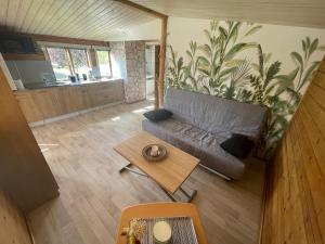 a living room with a couch and a table at Chalet LALi in Saint-Étienne-de-Fontbellon