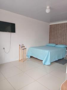 a bedroom with a bed and a flat screen tv at Mamela BNB in Elandsfontein +23 photos