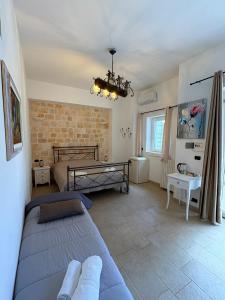 a bedroom with two beds and a brick wall at Villa don peppe in Selva di Fasano