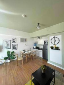 a living room with a table and a kitchen at Abreeza place T-2 in Davao City