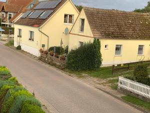 a house with solar panels on the roof on a street at Ferienhaus Boddensicht in Breege