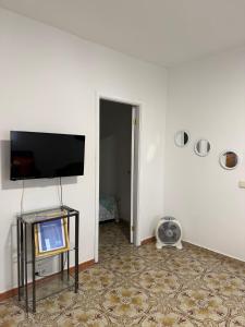 a living room with a tv and a table with a television at Nature in Tejeda 2 in Tejeda