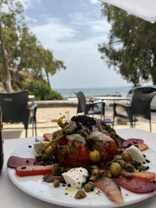 a plate of food on a table near the beach at Villa Alicante Beach in El Campello