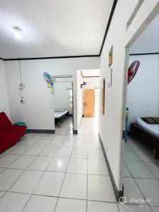 a room with two beds and a hallway at Tiga Dara Homestay 3 in Pangandaran +2 photos
