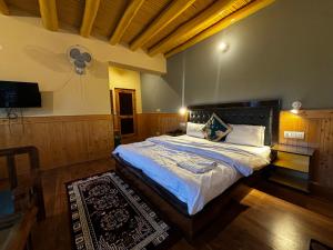 a bedroom with a large bed in a room at Zaltak Guest House and Hostel in Leh