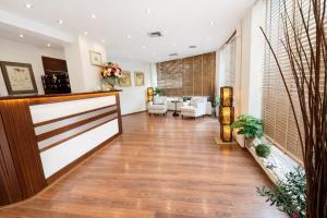a living room with a hallway with a wooden door at INOH Athens Hotel in Athens