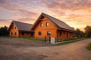 a large wooden house with a black roof at Chalupa Sandra in Vítějeves