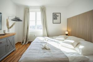 a bedroom with a large bed with two white towels on it at Central Station Apartment in Dessau