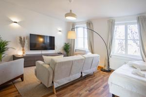 a living room with a couch and a tv at Central Station Apartment in Dessau
