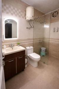 a bathroom with a toilet and a sink and a shower at Great Himalayan Resort in Dharmsāla +48 photos