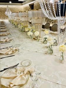 a long white table with glasses and flowers on it at Il Casale della Baronessa in Palmi