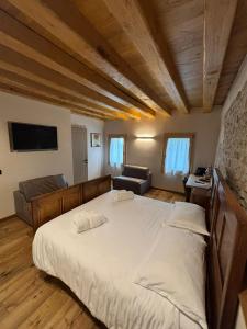 a bedroom with a large bed and a couch at Casa Tormena in Valdobbiadene