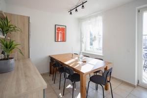 a dining room with a wooden table and chairs at Central Station Apartment in Dessau