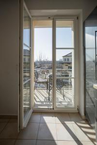 an empty room with sliding glass doors and a balcony at Central Station Apartment in Dessau