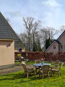 a table and chairs in a yard with a table and chairs at 't Sinnehûs in Sondel