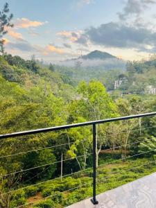 a balcony with a view of a forest at Ceylon tea resort Ella in Ella
