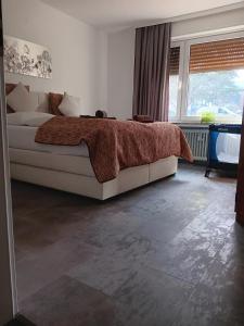 a bedroom with a bed with a blanket on it at Kontinental A in Bad Harzburg