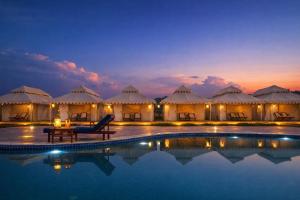 a villa with a pool in front of a resort at Limra Desert Camp With Swimming pool in Jaisalmer