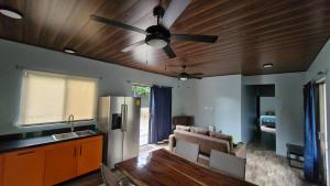 a kitchen with a table and a ceiling fan at House with a private pool in Ojochal