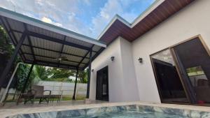 a house with a swimming pool and a patio at House with a private pool in Ojochal