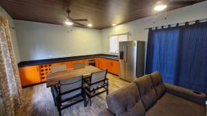 a kitchen with a couch and a table and a refrigerator at House with a private pool in Ojochal