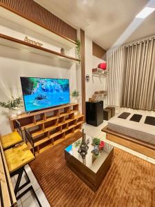 a living room with a flat screen tv on a wall at Copacabana, Design Elegante A 100m Do Mar in Rio de Janeiro