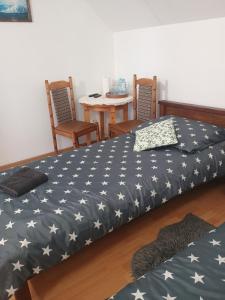 a bedroom with two beds and a table and chairs at Noclegi u Beaty in Dubiecko