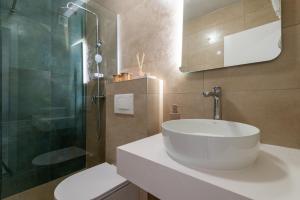 a bathroom with a sink and a glass shower at Apartments Sentic in Neum +56 photos