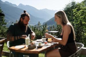 Ein Mann und eine Frau sitzen an einem Tisch und essen. in der Unterkunft ARPURIA - 4 Star Superior - Adults Only in Sankt Anton am Arlberg + 66 Fotos