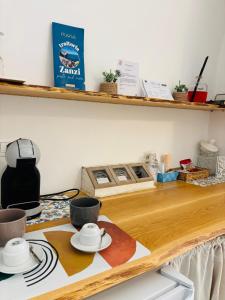 a kitchen counter with a table with dishes on it at Affittacamere Nalì in Polignano a Mare