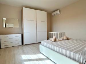 a bedroom with a bed and a dresser and a mirror at Villa La Palma in Camaiore +35 photos