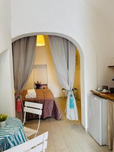 a bedroom with a bed in a room with an archway at Affittacamere Nalì in Polignano a Mare