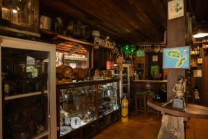 a room with a bar with a lot of items at Pousada Bob Pai & Bob Filho in Ilha do Mel +36 photos