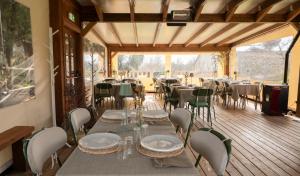 a dining room with tables and chairs on a deck at Agriturismo L'Accolta in Tuoro sul Trasimeno