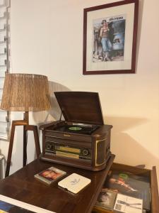an old radio sitting on a table next to a lamp at Bel apartment - Waterloo in Waterloo