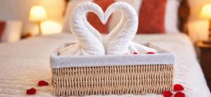 a towel basket with hearts on a bed at Knossos Skynest in Palekastron