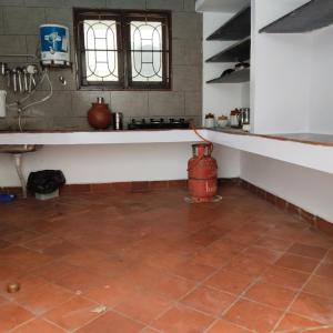 a kitchen with a tub and a sink and a vase at Natural bliss in Tiruchirappalli +18 photos