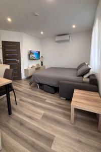 a bedroom with a bed and a wooden floor at ROYAL homes in Nesvady